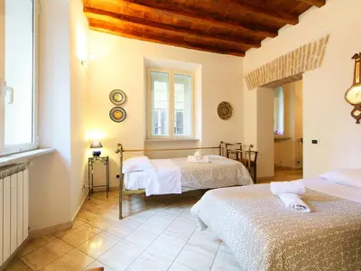 a bedroom with two beds and two windows at Apartment Vittorio Emanuele-1 by Interhome in Rome
