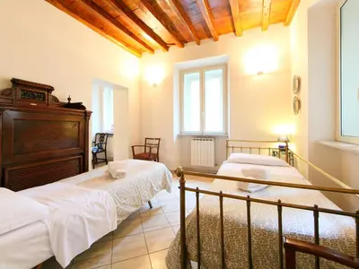 a bedroom with two beds and a wooden ceiling at Apartment Vittorio Emanuele-1 by Interhome in Rome