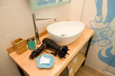 a bathroom with a sink and a microscope on a table at Private Modern Studio Paolina City Center in Rome