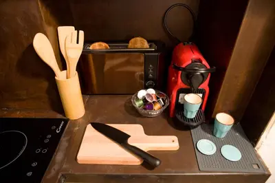 a kitchen counter with a red blender and a cutting board at Private Modern Studio Paolina City Center in Rome