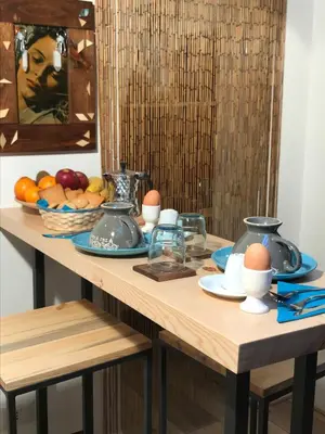 a table with eggs and a bowl of fruit on it at Private Modern Studio Paolina City Center in Rome