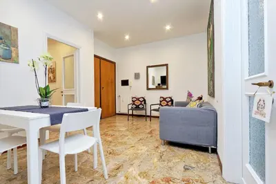 a living room with a table and chairs and a couch at YCH-TRASTEVERE cozy flat for 8 people in Rome