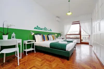 a bedroom with a green and white bed and a desk at YCH-TRASTEVERE cozy flat for 8 people in Rome