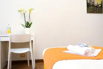 a bedroom with a bed and a desk and a chair at YCH-TRASTEVERE cozy flat for 8 people in Rome