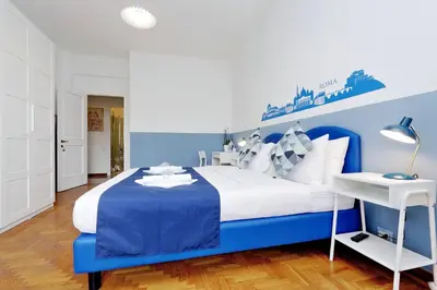 a blue and white bedroom with a large bed at YCH-TRASTEVERE cozy flat for 8 people in Rome
