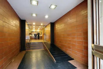 a hallway of a building with brown tiles at YCH-TRASTEVERE cozy flat for 8 people in Rome