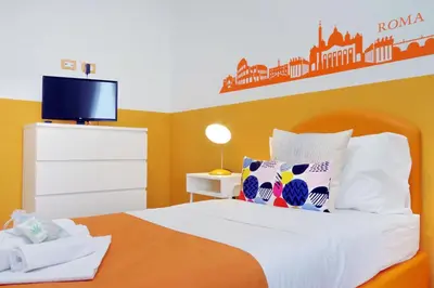 a bedroom with a bed and a tv on the wall at YCH-TRASTEVERE cozy flat for 8 people in Rome