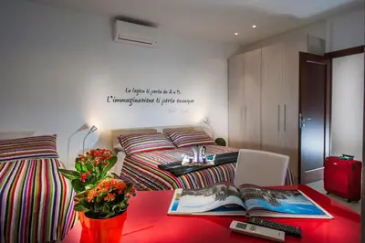 a room with a bed and a table with a book at Vatican Meadows in Rome