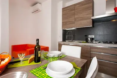 a kitchen with a table with a bottle of wine at Vatican Meadows in Rome