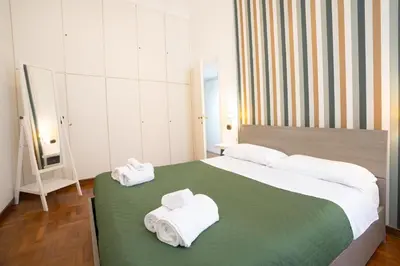 a bedroom with a large bed with towels on it at Vatican Apartment Borgo Pio in Rome