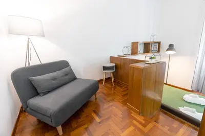 a living room with a chair and a desk at Vatican Apartment Borgo Pio in Rome