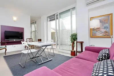a living room with a purple couch and a table at Piazza del Popolo Apartment in Rome