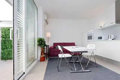 a living room with a table and a purple couch at Piazza del Popolo Apartment in Rome