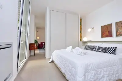 a white bedroom with a white bed in a room at Piazza del Popolo Apartment in Rome