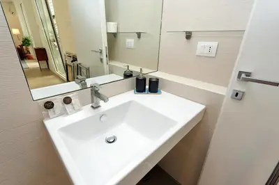 a bathroom with a white sink and a mirror at Piazza del Popolo Apartment in Rome