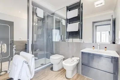 a bathroom with a toilet and a shower and a sink at Trevi area Penthouse in Rome