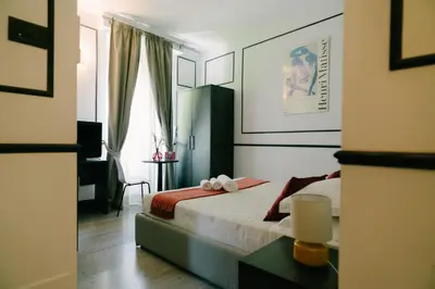 a bedroom with a bed and a window at Royal Suite du Vatican in Rome