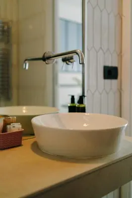 a white sink on a counter in a bathroom at Royal Suite du Vatican in Rome
