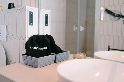 a trash can sitting on top of a bathroom counter at Royal Suite du Vatican in Rome