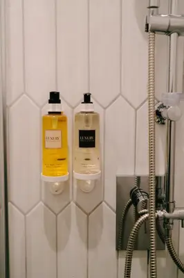 two bottles of soap are on the wall of a bathroom at Royal Suite du Vatican in Rome