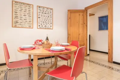 a dining room with a wooden table and red chairs at Elizabeth House - WelcomeToRhome in Rome