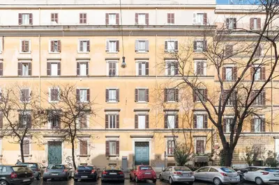 a large building with cars parked in front of it at Elizabeth House - WelcomeToRhome in Rome