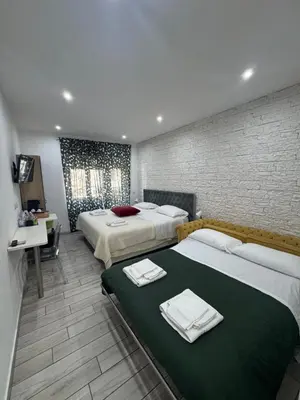 a hotel room with two beds with towels on them at San Pietro Dreaming Rooms in Rome