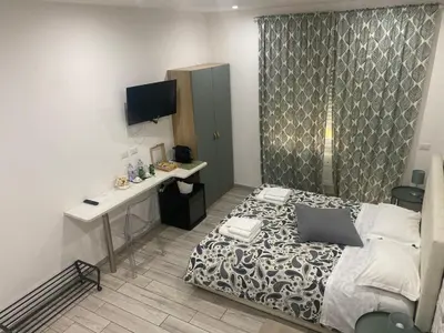 a small bedroom with a bed and a desk at San Pietro Dreaming Rooms in Rome