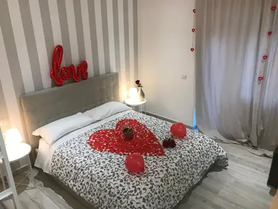 a bedroom with a bed with red hearts on it at San Pietro Dreaming Rooms in Rome
