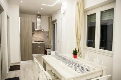 a kitchen and dining room with a table and chairs at San Pietro Dreaming Rooms in Rome
