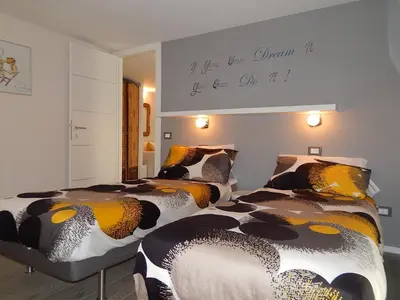 a bedroom with two beds and a sign on a wall at Modern Loft Walk to St Peter IREX Apartment in Rome