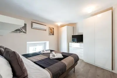 a bedroom with a bed with two towels on it at Modern Loft Walk to St Peter IREX Apartment in Rome