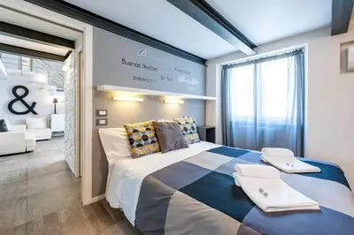 a bedroom with a large bed and a large window at Modern Loft Walk to St Peter IREX Apartment in Rome