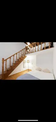 a bedroom with a staircase leading up to a bed at IN FRONT OF COLISEUM 3 in Rome