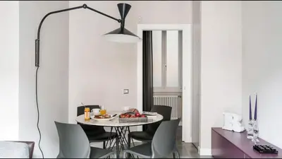 a dining room with a table and chairs at Moma Roma in Rome