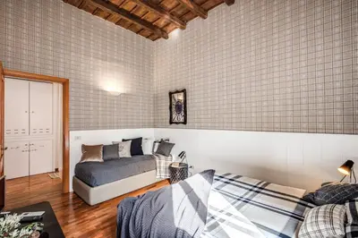 a bedroom with a bed and a couch in a room at Colosseo Miracle Suite in Rome
