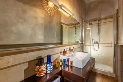 a bathroom with a sink and a mirror at Palm Suites - Small Luxury Hotels of the World in Rome