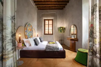 a bedroom with a large bed in a room at Palm Suites - Small Luxury Hotels of the World in Rome