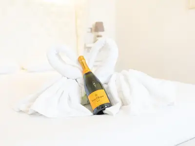 a bottle of wine in a bed with bunny ears at Romerooms Cola di Rienzo in Rome