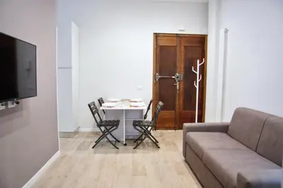 a living room with a couch and a table with chairs at Vatican Luxury Corner in Rome
