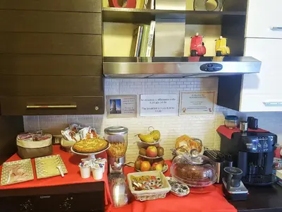 a counter with food on a red table at Vatican Luxury Corner in Rome