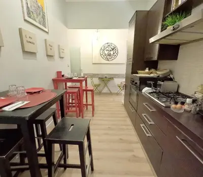 a kitchen with a counter and a table with chairs at Vatican Luxury Corner in Rome