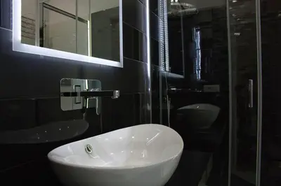 a bathroom with a white sink and a mirror at Vatican Luxury Corner in Rome