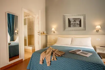 a bedroom with a bed with two books on it at Ottaviano Guest House in Rome