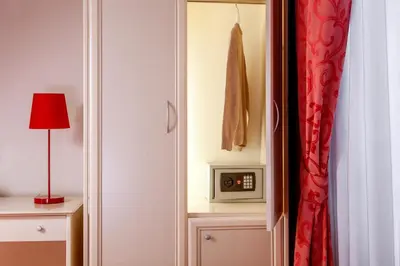 a bedroom with a door open to a room with a microwave at Ottaviano Guest House in Rome
