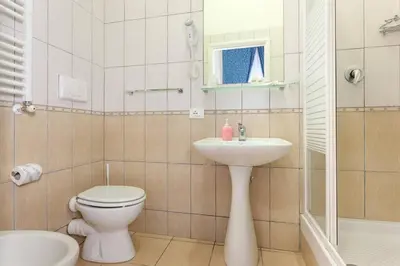 a bathroom with a toilet and a sink at Ottaviano Guest House in Rome