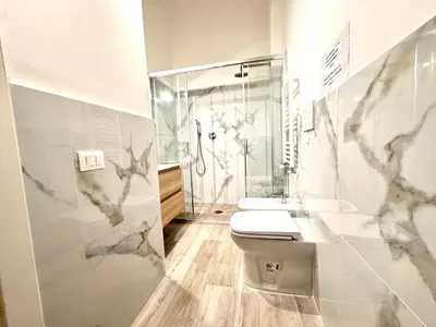 a white bathroom with a toilet and a shower at Exclusive Central Apartment 48 in Rome