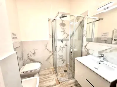 a bathroom with a shower and a toilet and a sink at Exclusive Central Apartment 48 in Rome