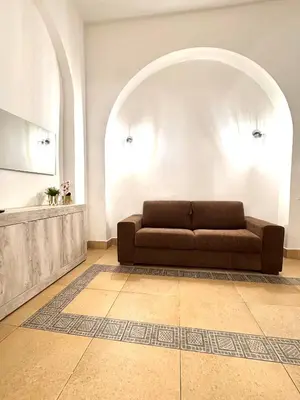 a living room with a brown couch in a room at Exclusive Central Apartment 48 in Rome
