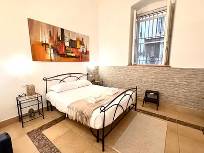 a bedroom with a bed and a painting on the wall at Exclusive Central Apartment 48 in Rome